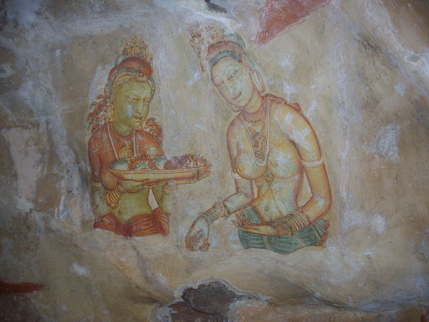 Ancient frescoes of the Sigiriya damsels painted on the rock face