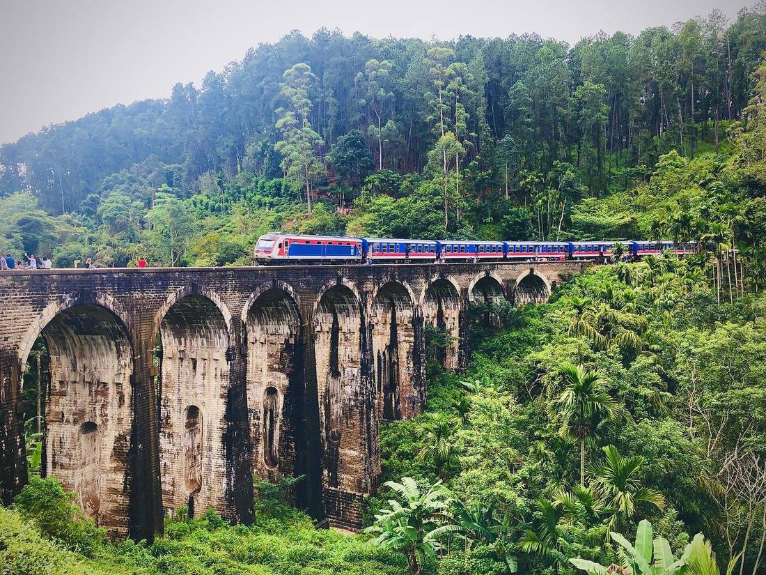 A train crossing the stone arches of Nine Arch Bridge
